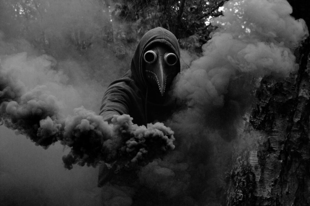 person in scary bird mask standing with smoke bomb in hand